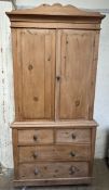 A Victorian pine linen press, the moulded cornice above two cupboard doors,