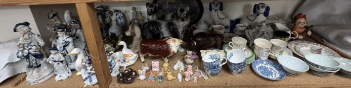 A pair of Staffordshire type dogs, together with a part tea service, pigs, tureen and cover,