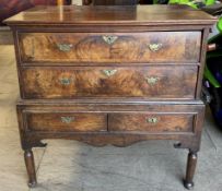 An 18th century and later oak and walnut chest on stand with a rectangular top above two long