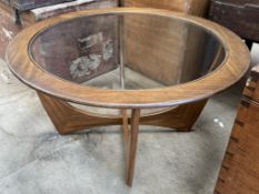 A G-Plan Astro teak coffee table of circular form with an inset glass top on shaped legs,