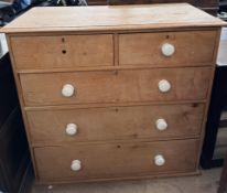 A Victorian pine chest with two short and three long drawers on a plinth