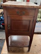 An Edwardian mahogany marble topped washstand with a frieze drawer and cupboard on square tapering