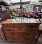 An Edwardian satin walnut chest with a central hat drawers and four short drawers with two long