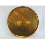 A large Indian engraved and spot hammered brass tray. With concentric bands of scrolling foliate and