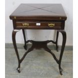 Edwardian mahogany envelope card table with a green baize over a frieze drawer and cabriole legs.