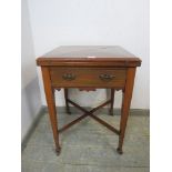 A late 19th/early 20th Century envelope topped mahogany card table opening to a baise lined top with