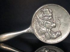 Ornate white metal hand mirror