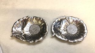 Pair of silver-plated floral dishes with a petal and leaf design and textured details. The dishes