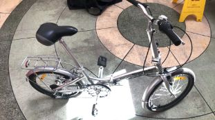 Vintage Milan Explorer Bicycle: Features a charming aluminum frame, rear rack, and adjustable seat.