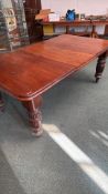 Victorian mahogany extending dining table with gadrooned legs on brass castors. Includes