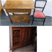 An early 20th century mahogany display cabinet having a gadrooned cornice and standing on ball and