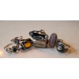 Seven silver and white metal dress rings, some having inset semi precious stones, one inset with
