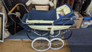 A millennium silver cross pram numbered 705 with paperwork and two Diana Effner dolls Location: