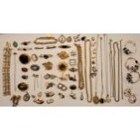 A group of gold tone and yellow metal jewellery to include a long hat pin with 9ct gold front, a 2