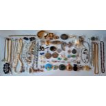 A quantity of vintage costume jewellery to include brooches and clips, 1950's lifesaver medals,