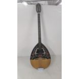 A 20th century octave mandolin measuring 37.5 inches in length with a butterfly and floral