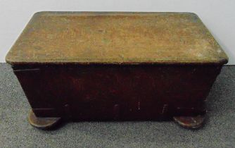 An antique oak campaign chest of rectangular form with side handles on four bun feet, 35 x 76 x