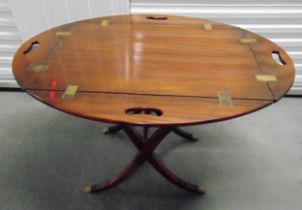 A mahogany Butlers tray with brass hinged sides on an X frame stand, 62.5 x 100 x 75cm