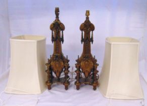 A pair of late 19th century gilt metal table lamps profusely decorated