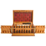 A walnut-cased games compendium, containing wooden chess set, dominos, draughtsmen, etc, case
