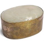 A Chinese engraved brass oval box, the lid set with relief carved 18th century jade plaque depicting