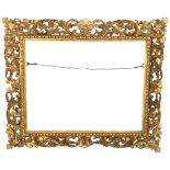 A Florentine carved giltwood frame, rebate size 61cm x 77cm The 4 corners have been damage and re-