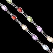 A sterling silver rainbow gem set tennis line bracelet, gemstones include amethyst, garnet,