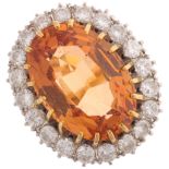 An 18ct gold Imperial topaz diamond cluster ring, maker J & P, London 1975, the oval cluster claw