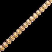 A Contemporary sterling silver citrine tennis line bracelet, set with oval mixed-cut citrines, 18cm,