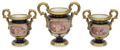 A garniture of early 19th century English twin scroll handled vases