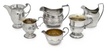 A collection of five silver jugs