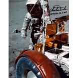 Apollo 16 Astronaut Charlie Duke signed 10x8 inch colour photo on the moon standing by the Rover
