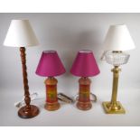 A pair of decorative turned wood table lamps, a wooden twist column table lamp and a brass and glass