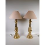 A pair of turned brass table lamps, 46cm high