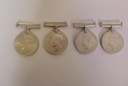 Two George VI 1939-45 Defence Medals, and two 1939-45 War Medals, unmarked