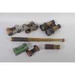 An antique brass four draw telescope and another smaller, a pair of WWI binoculars and three pairs