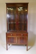 Victorian mahogany display cabinet, the two glazed doors with arched glazing bars and glass shelves,
