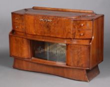Stonehill Furniture, a 1960's walnut finished cocktail cabinet, the centre section with cocktail