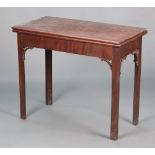 A George III rectangular mahogany cantilever card table, raised on chamfered supports with pierced