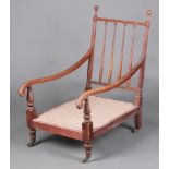 A Colonial rosewood stick and rail back open arm chairs, raised on brass caps and casters 98cm h x