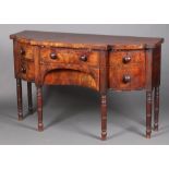 A Georgian mahogany breakfront sideboard fitted a drawer above secret drawer, flanked by a drawer