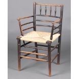 William Morris, an ebonised elm Sussex stick and rail back chair with later woven rush seat 85cm h x