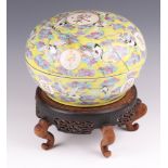 A late 19th Century Chinese circular yellow bowl and cover, the lid decorated storks amidst branches