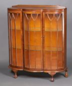 A 1930's Art Deco walnut display cabinet with raised back fitted 2 glass shelves enclosed by