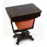 A 19thC coromandel sewing table with a short fitted drawer above a deep material lined drawer raised