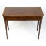 A late Georgian mahogany card table with canted corners, dual gate leg mechanism and a hinged top
