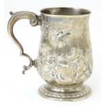 A George III silver mug / tankard with repousse decoration, hallmarked London 1817. Approx. 5"