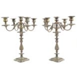 A pair of silver plate table candelabrum having acanthus and C-scroll decoration and four