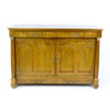 A 19thC continental walnut sideboard / cupboard with a figured walnut top above two short drawers