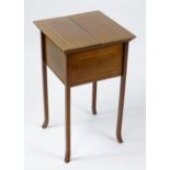 An early / mid 20thC mahogany sewing table with two hinged lids above decorative checkered inlay and